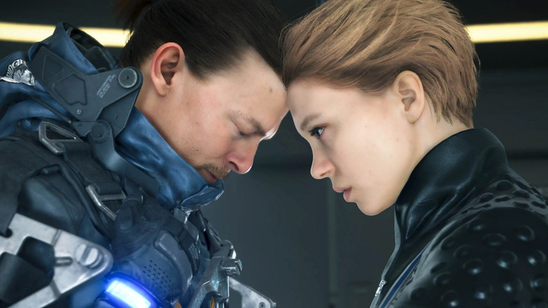 Norman Reedus and Léa Seydoux standing forehead to forehead in Death Stranding