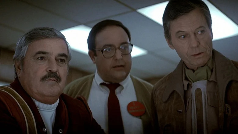 Scotty, an engineer, and Dr. McCoy looking at something in Star Trek IV: The Voyage Home