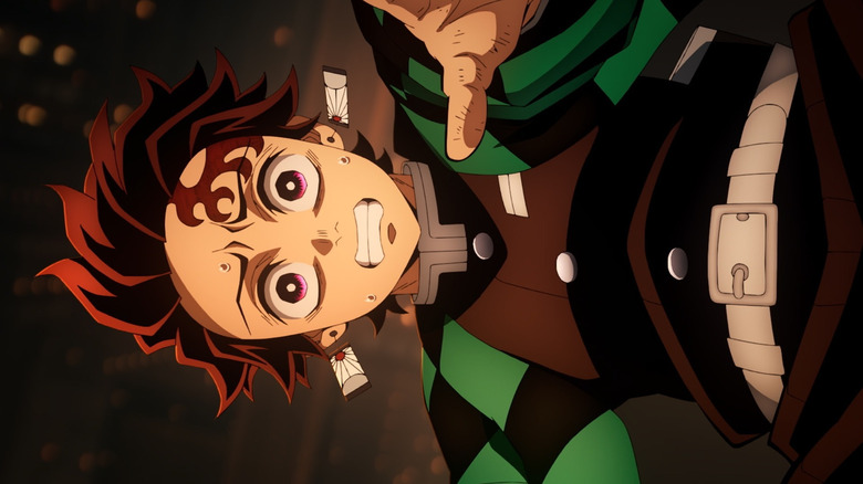 Tanjiro Kamado falliing while reaching forward in Demon Slayer: Kimetsu no Yaiba Infinity Castle
