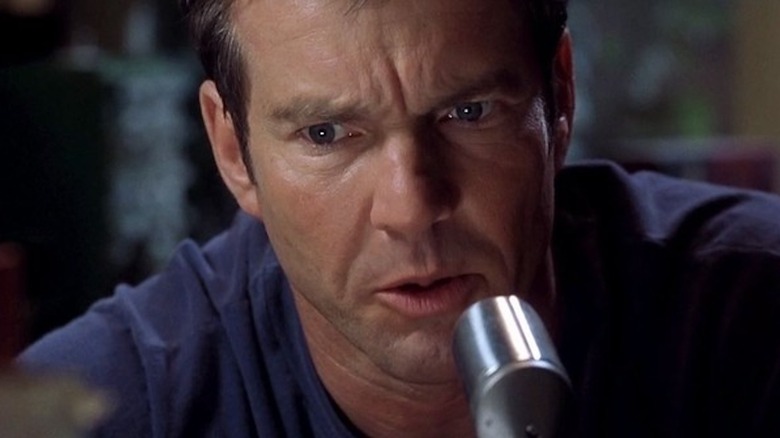 Dennis Quaid speaks into a ham radio microphone as Frank Sullivan in Frequency