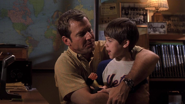 Dennis Quaid as Frank Sullivan hugging his young son in Frequency