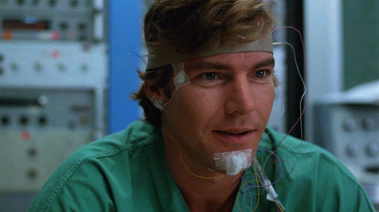 Dennis Quaid as Alex Gardner with wires taped to his head in Dreamscape