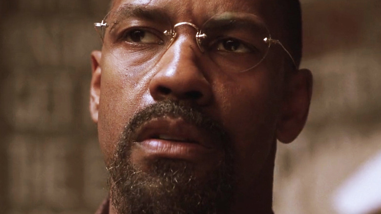 Denzel Washington's Rubin Carter is seen in closeup wearing glasses in The Hurricane