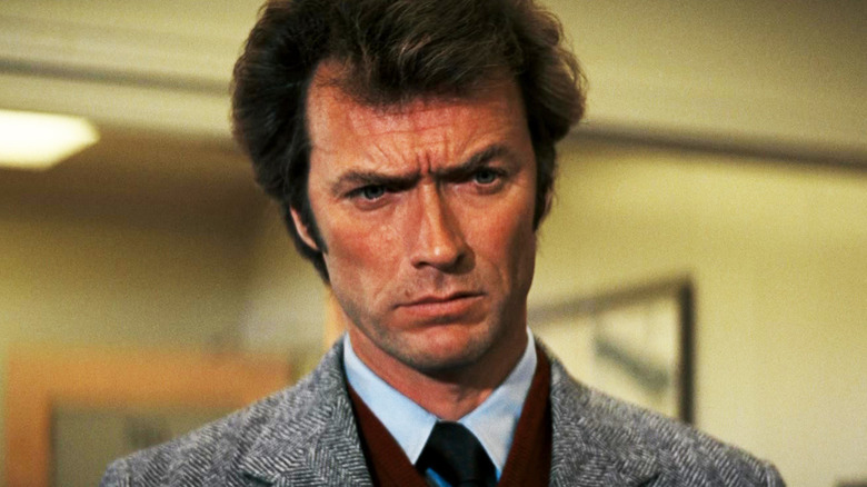 Clint Eastwood's Harry Callahan stands scowling in an office in Dirty Harry