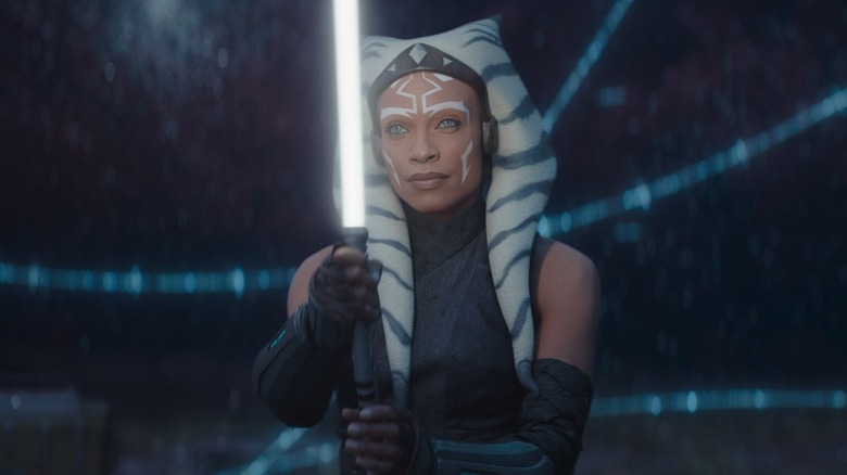 Rosario Dawson as Ahsoka Tano holding her lightsaber in the world between worlds in Ahsoka season 1