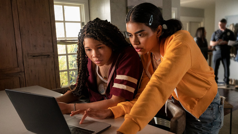Storm Reid as June and Megan Suri as Veena searching on their laptop in Missing