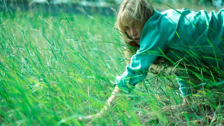 Grace crawls through the grass in Die My Love