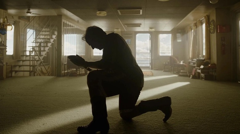 Tom Cruise as Digger Rockwell kneeling with his shovel in Digger