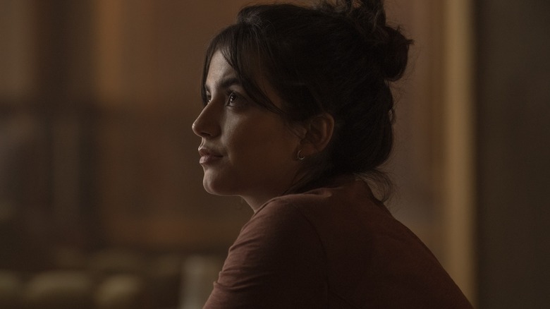 Dina with her hair in a bun looking up on The Last of Us