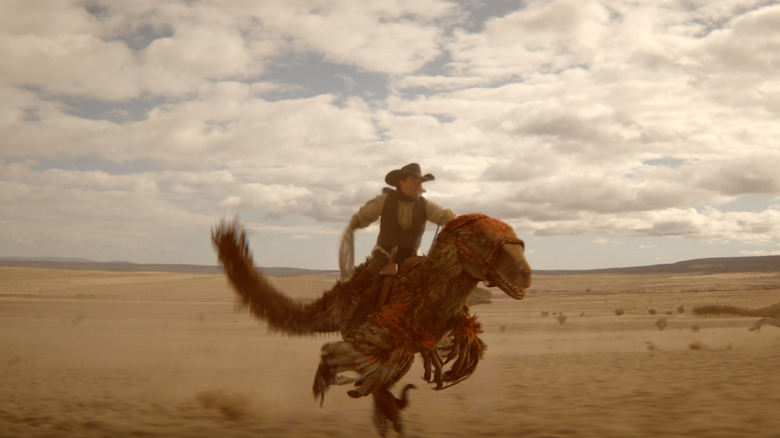 A cowboy riding a raptor in Dinosaurs of the Wild West