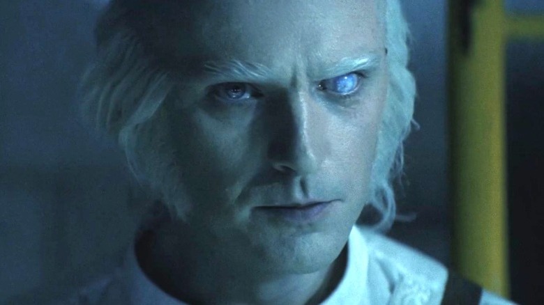 Dr. Kammler stares intently at something off screen in Onslaught