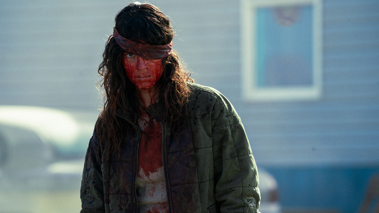 Celeste is covered in viscera and has her eye wrapped in a bandana in Onslaught