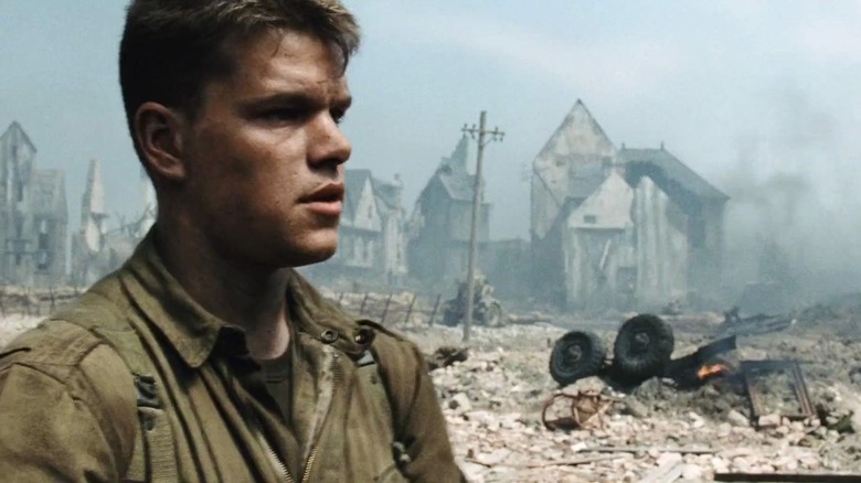 Private Ryan next to a bombed-out city in Saving Private Ryan