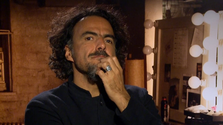 Alejandro G. Iñárritu scratching his chin when talking about Birdman