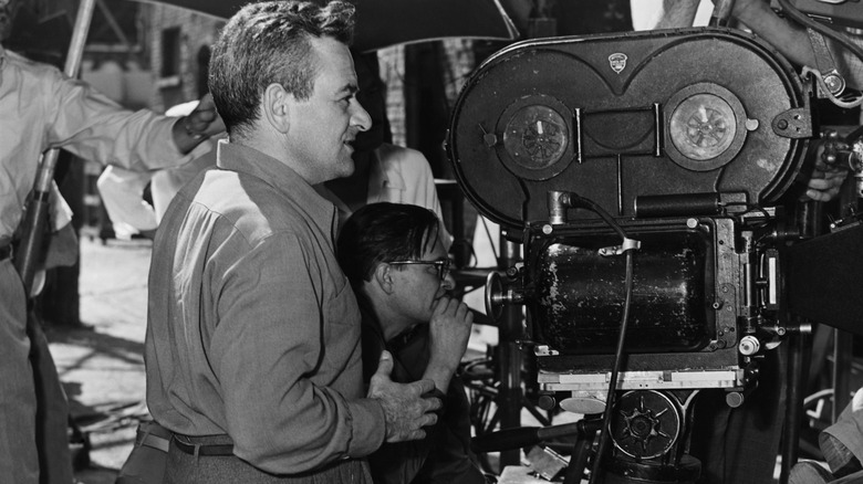 William Wyler standing behind camera on set of The Best Years of Our Lives
