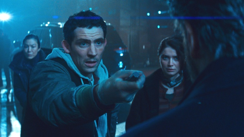 Daniel, with Eve next to him, holds out the device to Noah in Disclosure Day