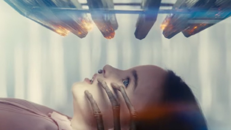 Margaret being touched on her face by an alien under The Devices in Disclosure Day
