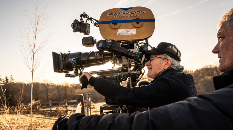Steven Spielberg looks through a camera lens while filming Disclosure Day