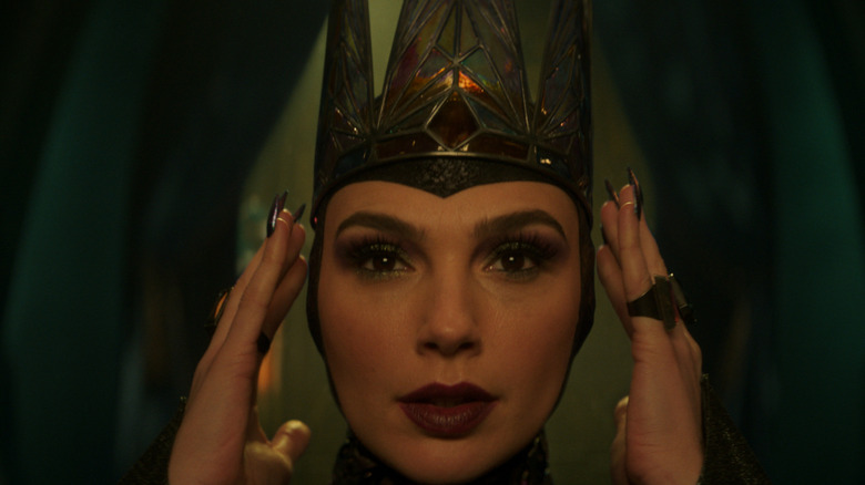 Gal Gadot as the Evil Queen adjusting her crown in Snow White (2025)