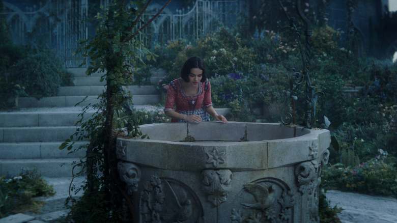 Rachel Zegler's Snow White looking down the well in Snow White (2025)