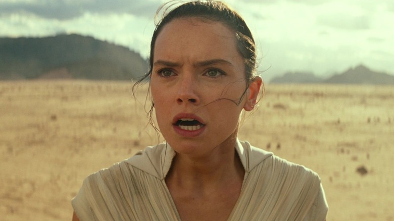 Daisy Ridley as Rey looking up to the sky in horror in Star Wars: The Rise of Skywalker