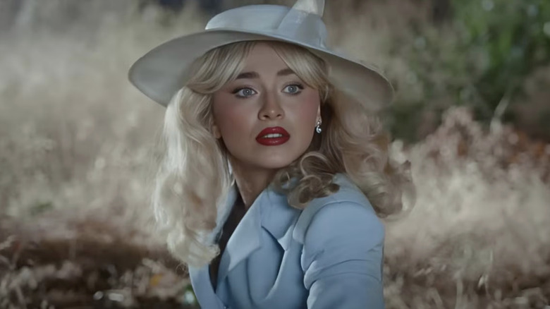 Sabrina Carpenter in a matching dress and hat in a field in the Tears music video