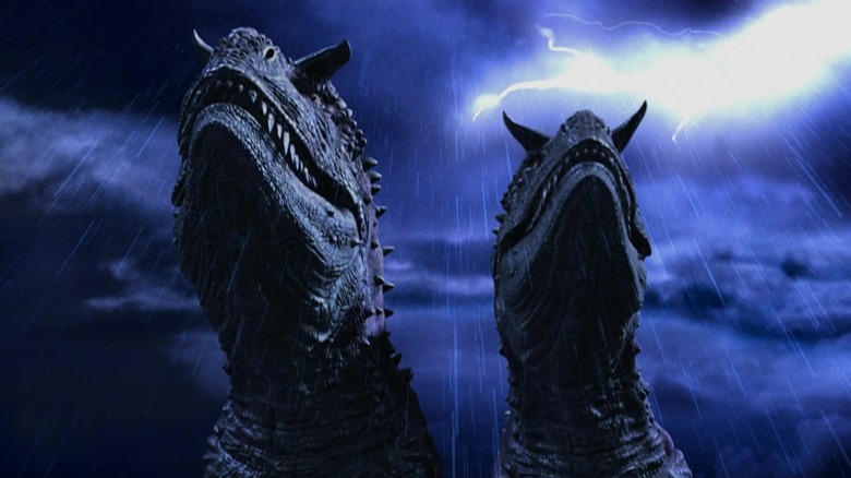 Twee carnotaurus lopen in de regen in Dinosaur