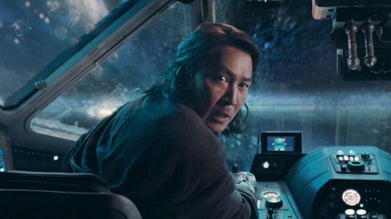 Lee Jung-jae as Master Sol looking alarmed while piloting a spaceship in Star Wars: The Acolyte