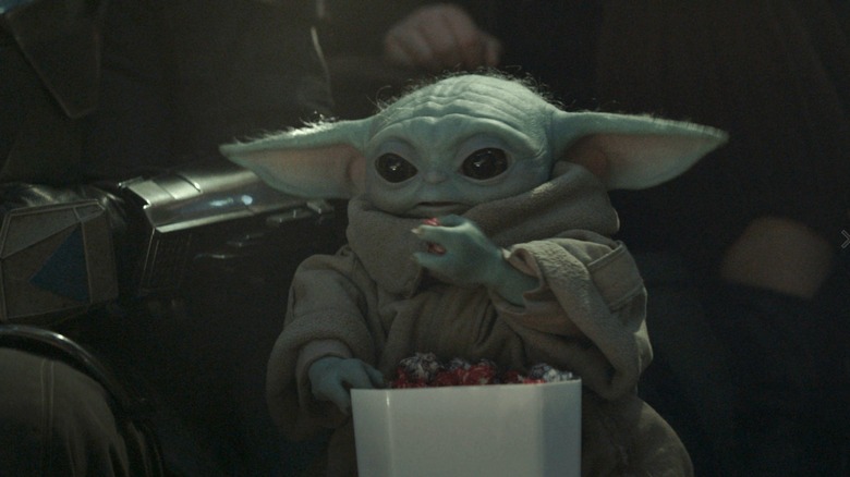 Grogu eating a bucket of snacks in The Mandalorian and Grogu