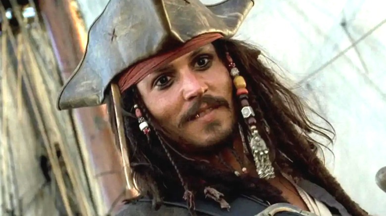Jack Sparrow smirking on a ship in Pirates of the Caribbean: The Curse of the Black Pearl