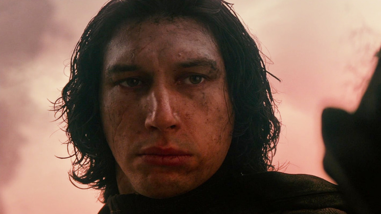 Adam Driver as Kylo Ren holding a Sith wayfinder in Star Wars: The Rise of Skywalker