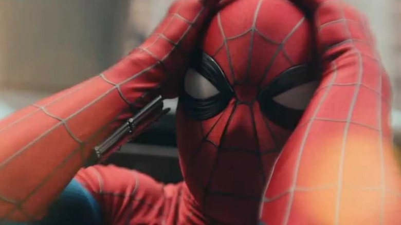 Spider-Man holds his head in pain in Spider-Man: Brand New Day