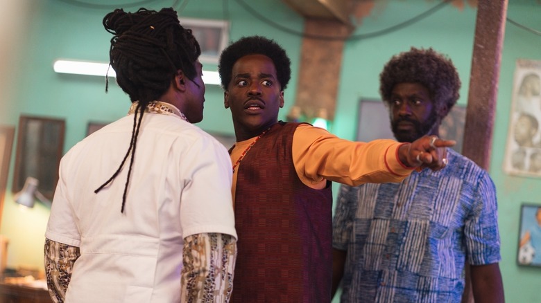 Ariyon Bakare's Barber, Ncuti Gatwa's the Doctor, and Sule Rimi's Omo in the barbershop on Doctor Who
