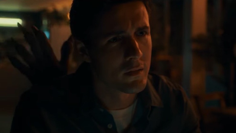 Jonah Hauer-King as Conrad with a clawed hand behind his back on Doctor Who