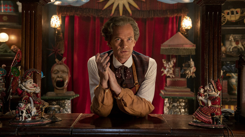 Neil Patrick Harris as the Toymaker behind a counter on Doctor Who