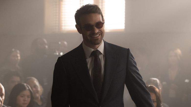 Charlie Cox as Matt Murdock smiling in the courtroom in Daredevil: Born Again