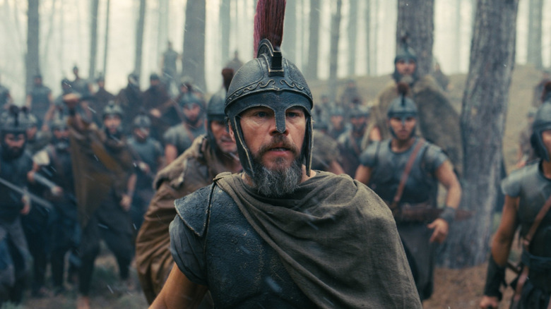 Matt Damon as Odysseus standing in front of his army in the woods in The Odyssey