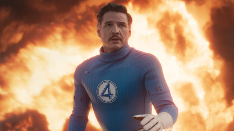 Pedro Pascal as Reed Richards standing in front of flames in The Fantastic Four: First Steps