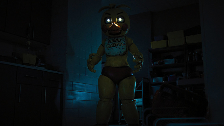 Toy Chica emerging from a shadowy hallway in Five Nights at Freddy's 2