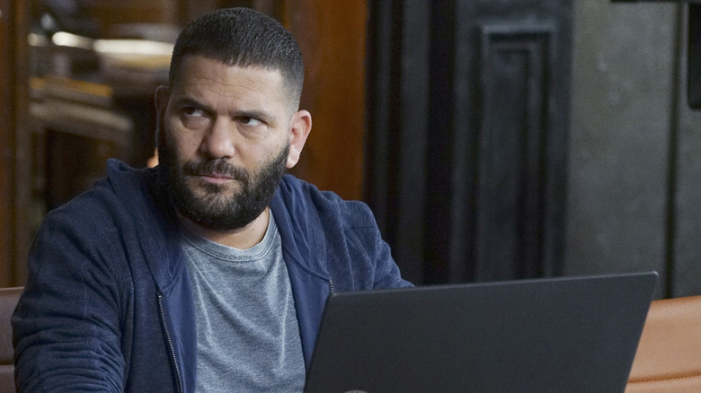 Huck at the OPA office looking to the side and working on his laptop