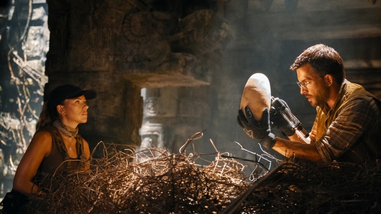 Zora Bennett and Dr. Henry Loomis look at a dinosaur egg in Jurassic World rebirth