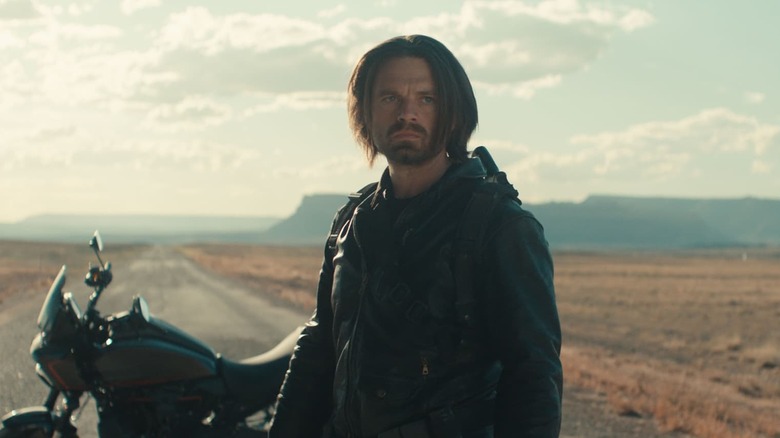 Sebastian Stan as Bucky standing in the road next to his motorcycle in Thunderbolts