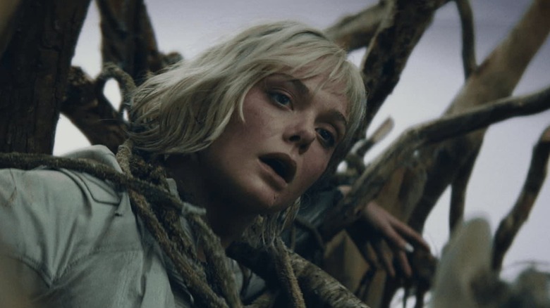 Elle Fanning as Thia wrapped up in tree branches in Predator: Badlands