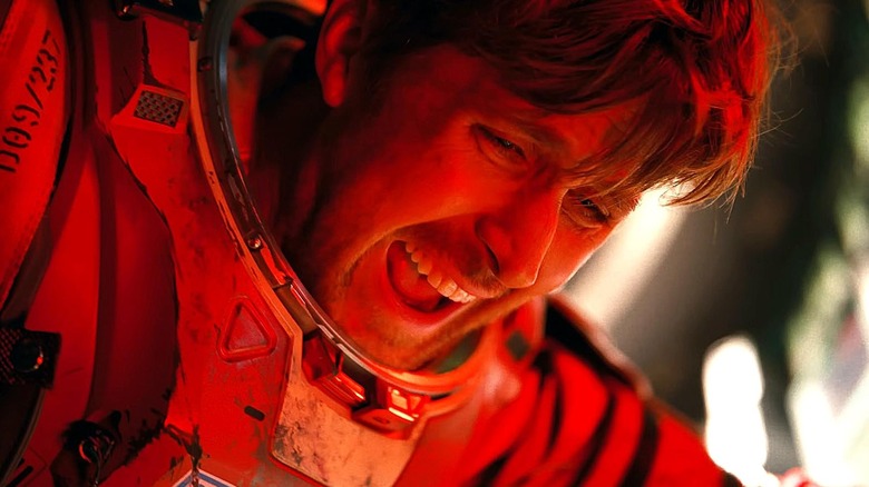 Ryan Gosling as Ryland yelling bathed in red light in Project Hail Mary