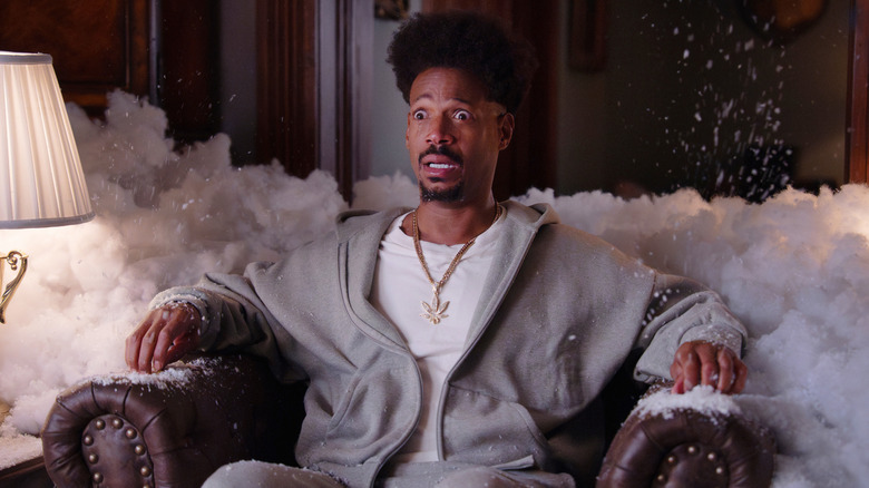 Marlon Wayans as Shorty sinking into a chair in Scary Movie (2026)
