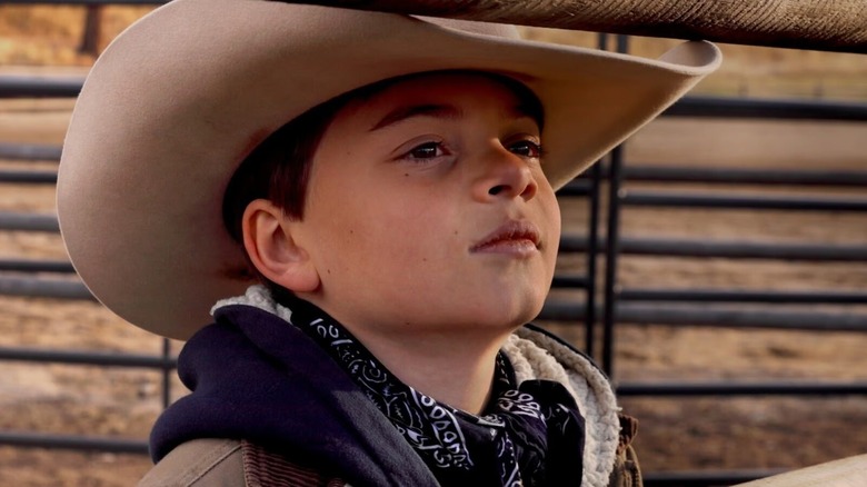 Tate Dutton is smiling and wearing a cowboy hat in Yellowstone