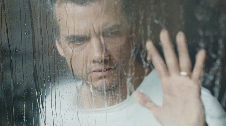 Jason looks out a rain-streaked window in The Last House