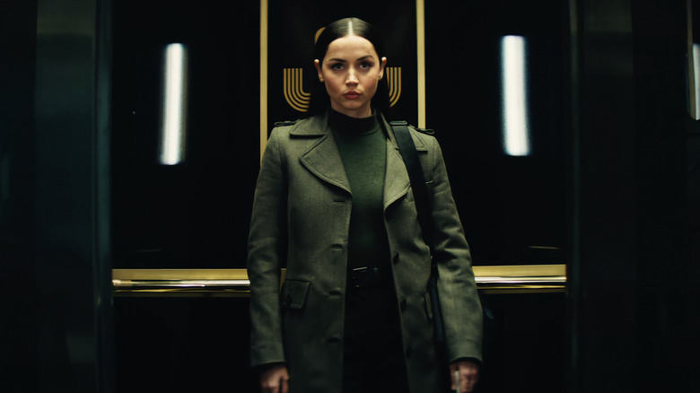 Ana de Armas as Eve stands in an elevator alone in Ballerina