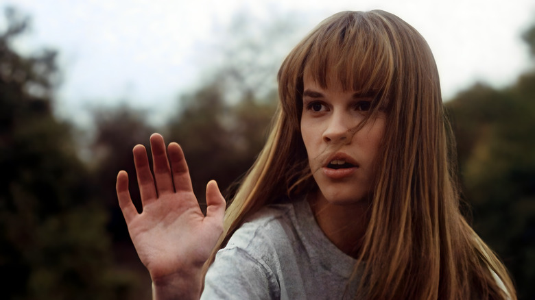 Julie Pierce with her raised hand 