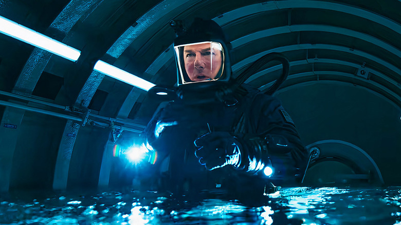 Ethan Hunt (Tom Cruise) in a heavy bodysuit standing in a submerged submarine